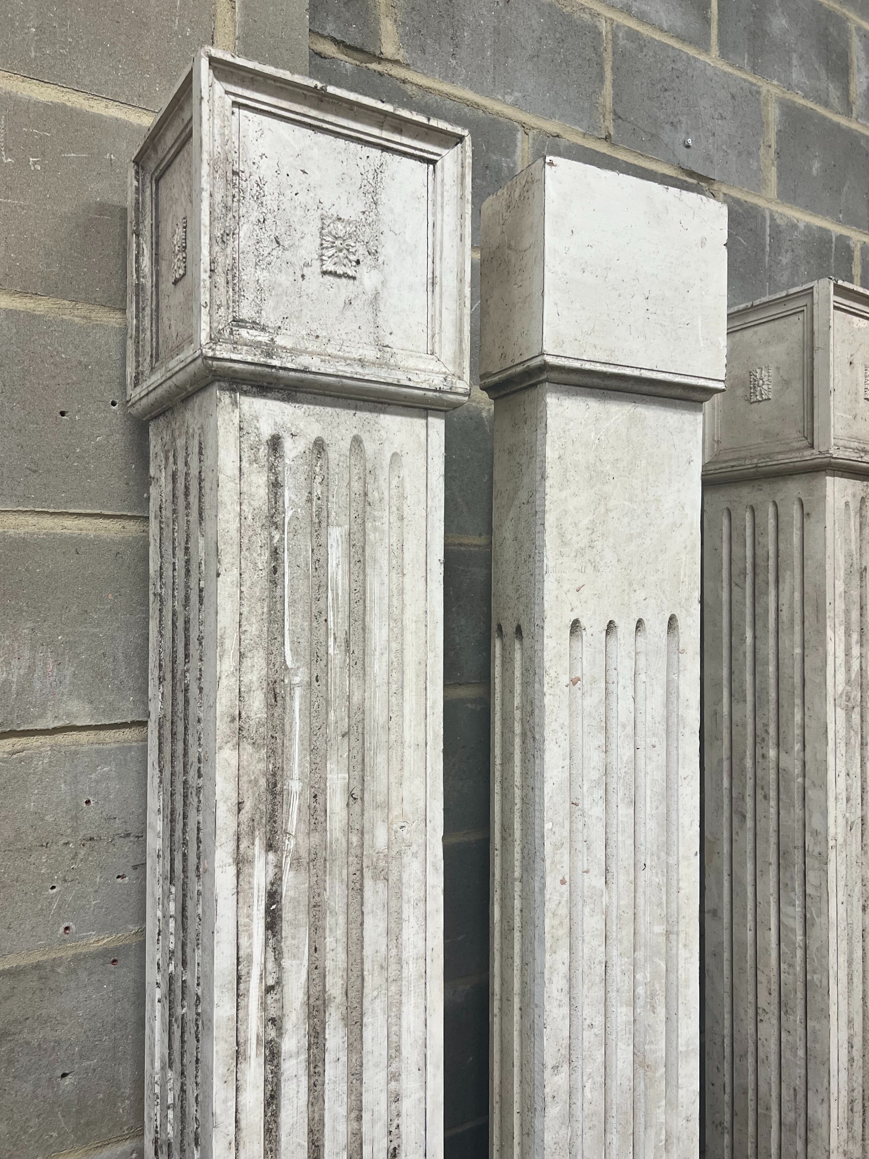 Four painted wood fluted square columns, tallest 222cm